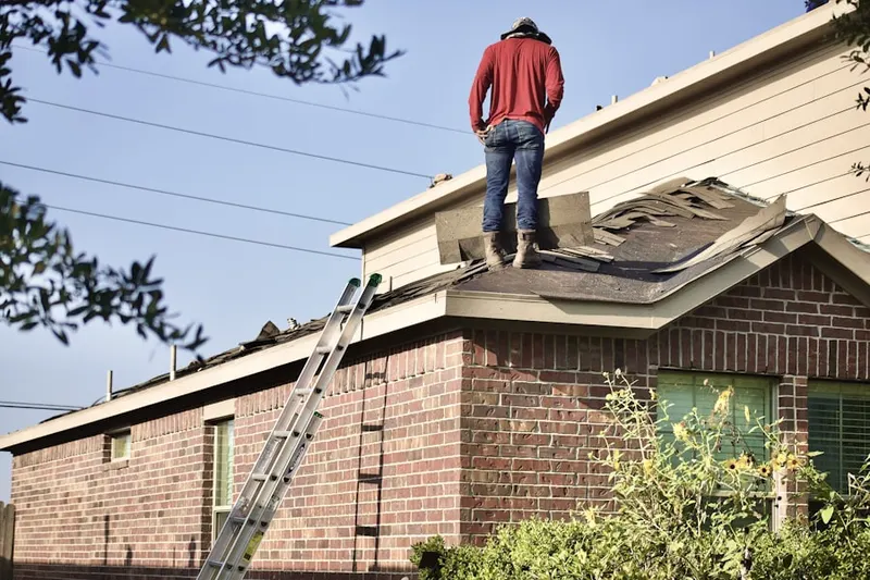 Professional roofer working on a residential roof in Dubuque